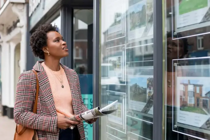 Female estate agent showing a modern property to a prospective buyer