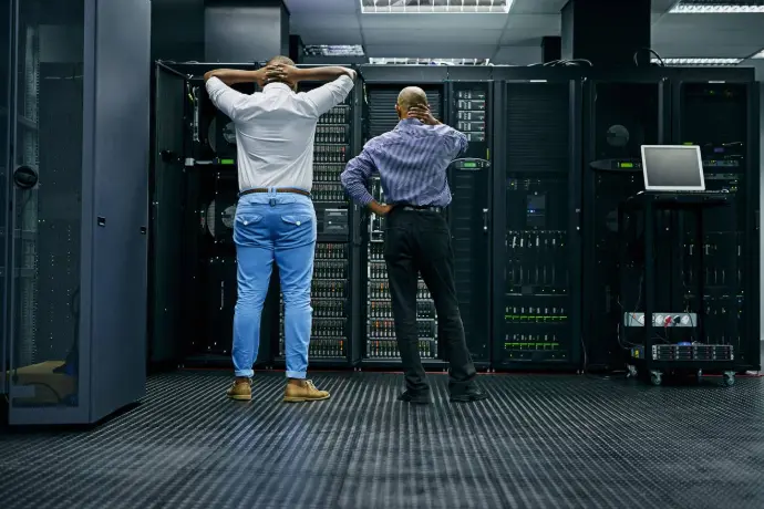 Two technicians working in a secure data centre